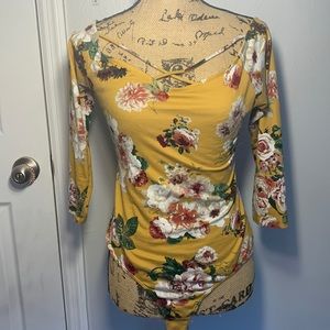 Floral body suit, stretchy and fitted in the color mustard.